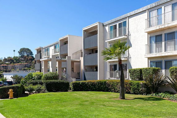 Front view of a multi-story apartment building with balconies.