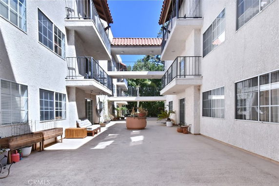 View of a multi-story building with balconies and a central open area.