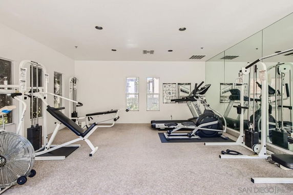 Indoor gym with exercise equipment and mirrored wall