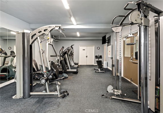 Indoor gym area with various exercise equipment.