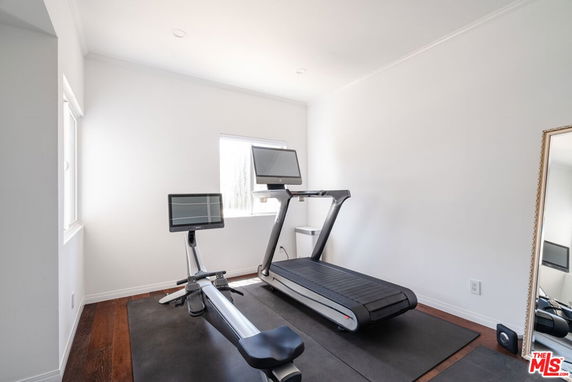 Small indoor gym area with a treadmill and exercise bike.
