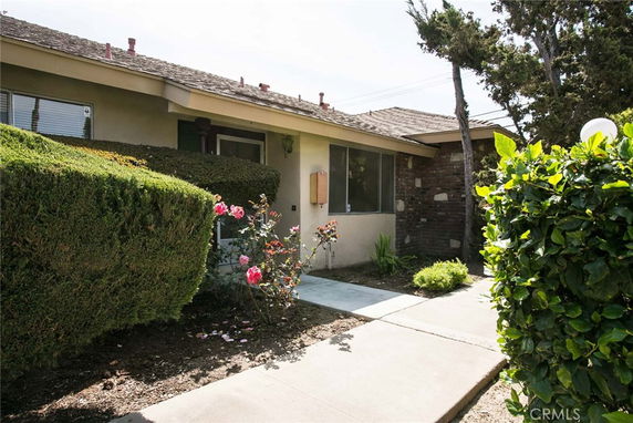 Front view of a single-story house with a garden path.