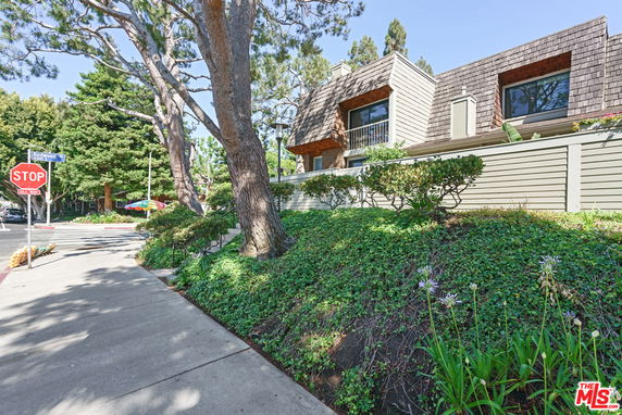 Front view of a multi-story house with wooden siding and modern architecture.