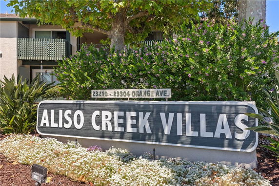 Front view of a building with a visible sign reading 'Aliso Creek Villas'.