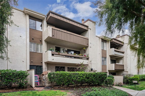 Front view of a multi-story building with balconies.