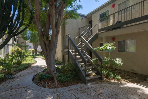 Front view of a two-story apartment building with external staircases.