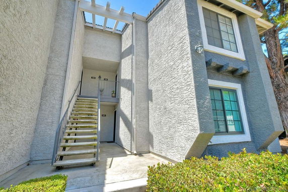 Front view of a two-story building with an exterior staircase.