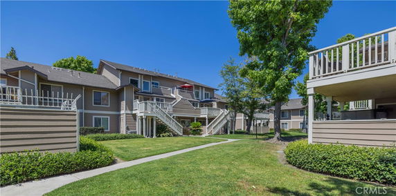 Front view of multiple two-story residential buildings with outdoor stairs and balconies.