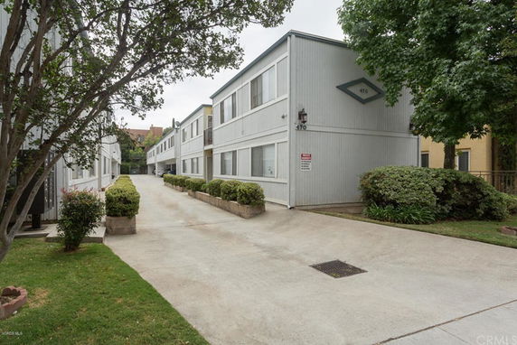 Front view of a two-story apartment building with a driveway.