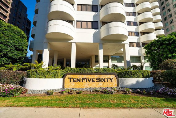 Front view of a multi-story building with rounded balconies and a sign reading 'Ten Five Sixty'.