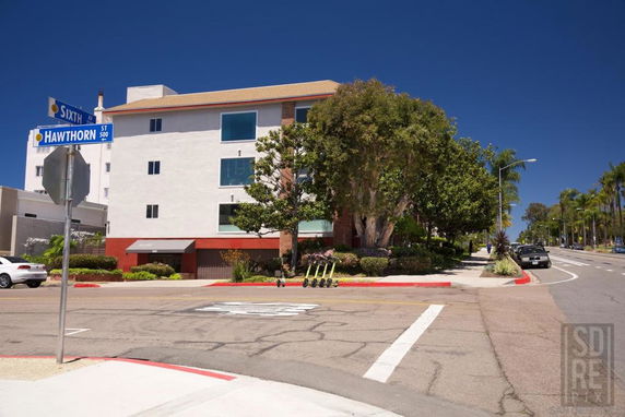 Front view of a multi-story building at a street corner.