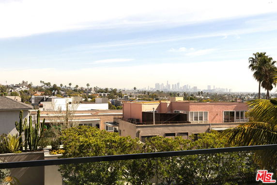 Panoramic view of urban landscape with distant city skyline.