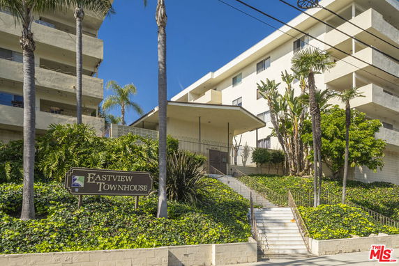 Front view of a multi-story townhouse building with a sign reading 'Eastview Townhouse'.