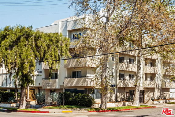 Front view of a multi-story apartment building with balconies.