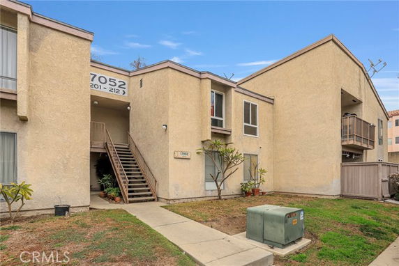 Front view of a two-story apartment building with external staircases.