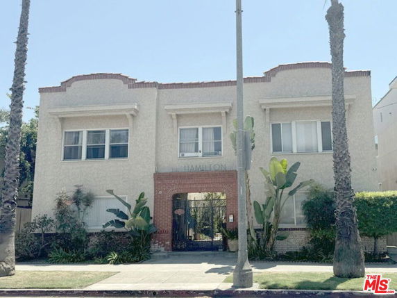 Front view of a two-story building with a central entrance and large windows.