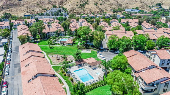 Panoramic view of a residential area with multiple buildings and a swimming pool.