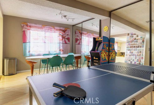 Recreation area with a ping pong table and arcade machine.