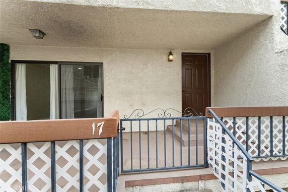 Front view of a building with a front door and sliding glass door.