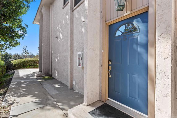 Side view of a building entrance with a blue door.