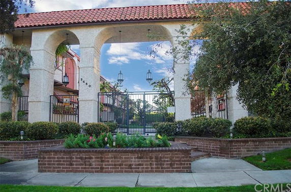 Front view of a building with an arched entrance and decorative lanterns.