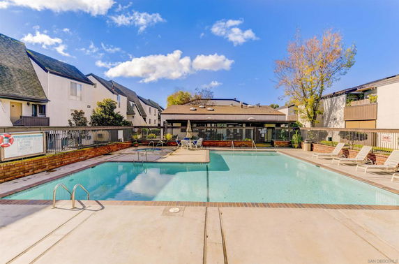 Outdoor swimming pool surrounded by residential buildings.