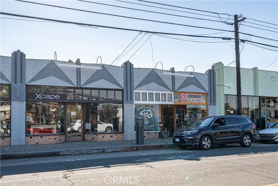 Front view of a single-story commercial building with a modern facade and large windows.