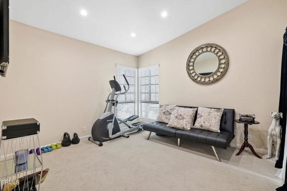 Indoor room with exercise equipment and seating area.