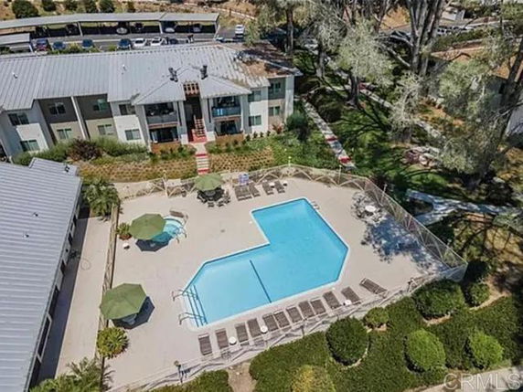 Aerial view of a swimming pool and an apartment building.
