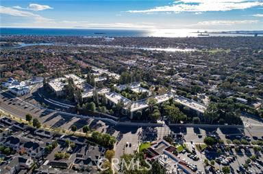 Panoramic view of a residential area with a river and ocean in the background.