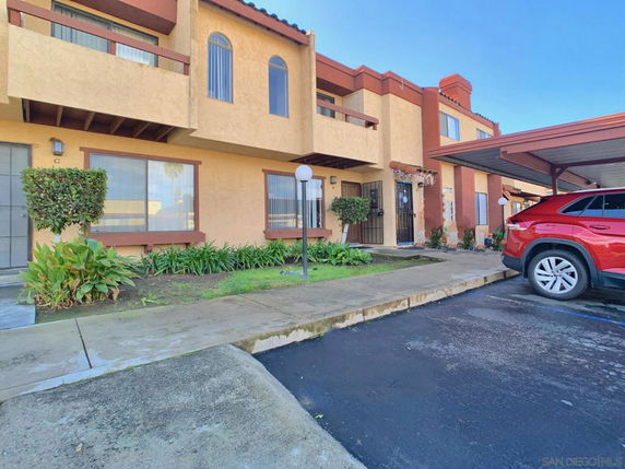 Front view of a two-story building with parking area.
