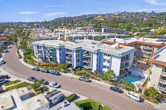 Aerial view of a multi-story apartment complex with modern architecture.