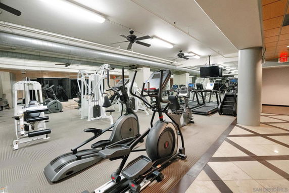 Indoor gym with various exercise equipment.