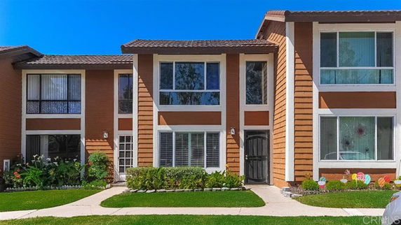 Front view of a two-story townhouse with large windows.
