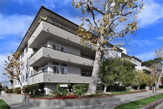 Front view of a multi-story residential building with balconies.