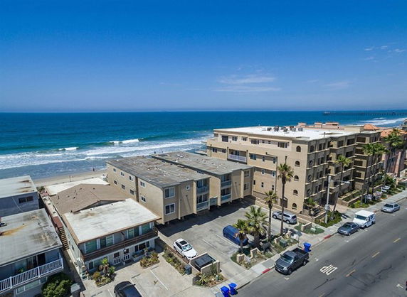 View of beachfront buildings near the ocean.