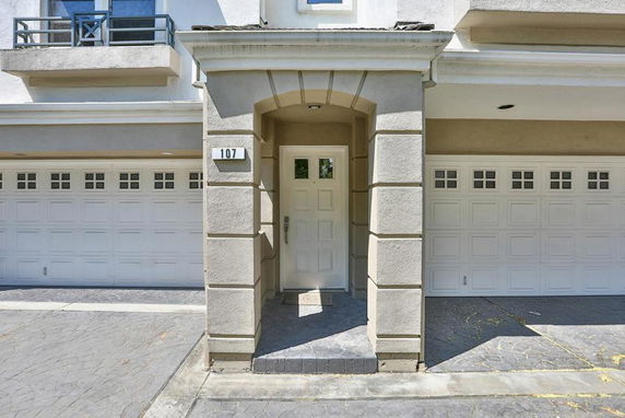 Front view of a house with two garages and a central entrance.