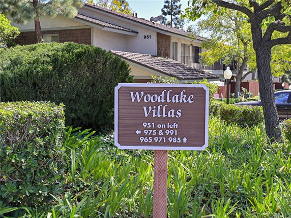 Front view of a two-story residential building named Woodlake Villas.