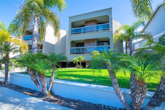 Front view of a multi-story residential building with balconies.