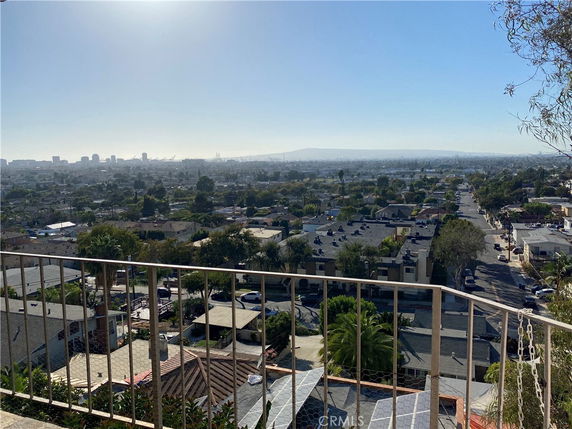 Panoramic view of a cityscape with buildings and roads seen from a high vantage point.