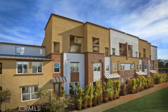 Front view of a multi-story apartment building with modern architecture.