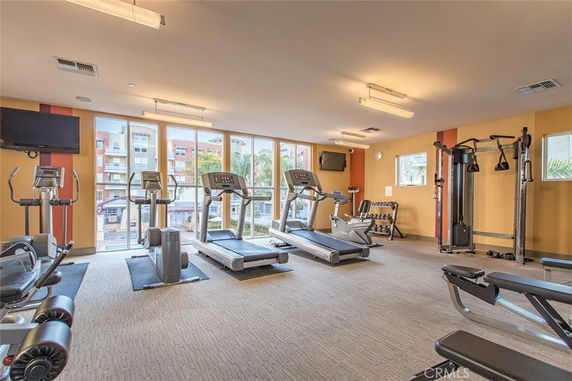 Indoor gym area with various exercise machines and equipment.