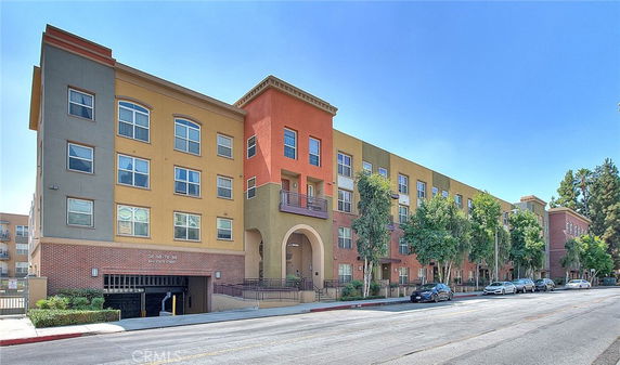 Front view of a multi-story residential building with colorful facade.