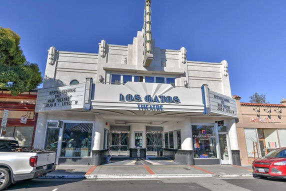 Front view of a theater with a prominent marquee and art deco architectural style.