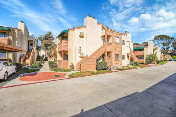 Front view of multi-story residential buildings with external stairs.