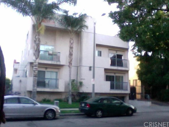 Front view of a multi-story residential building with balconies.