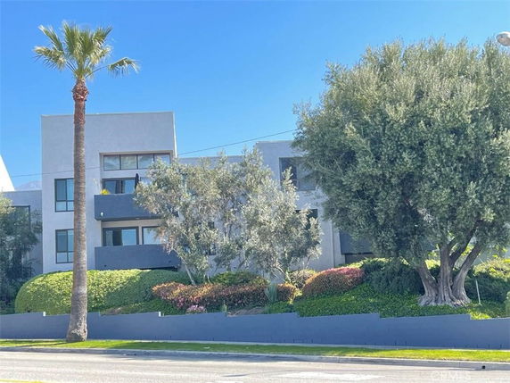 Front view of a modern multi-story building with a minimalist design.