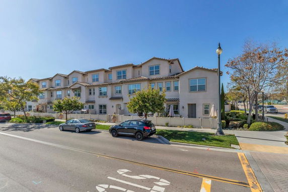 Front view of a multi-story residential building with multiple units.