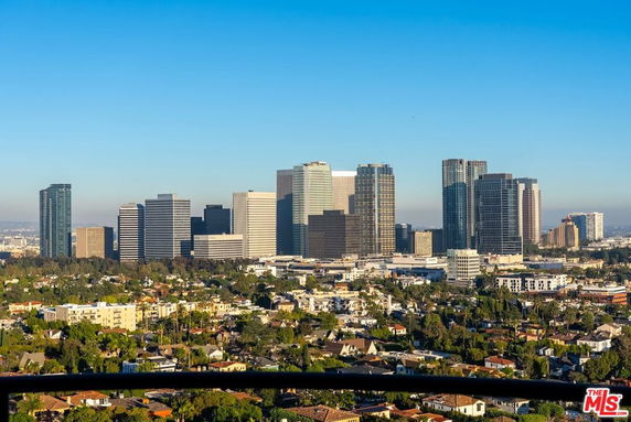 Panoramic view of city skyline with numerous tall buildings.
