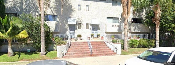 Front view of a multi-story building with a staircase entrance.